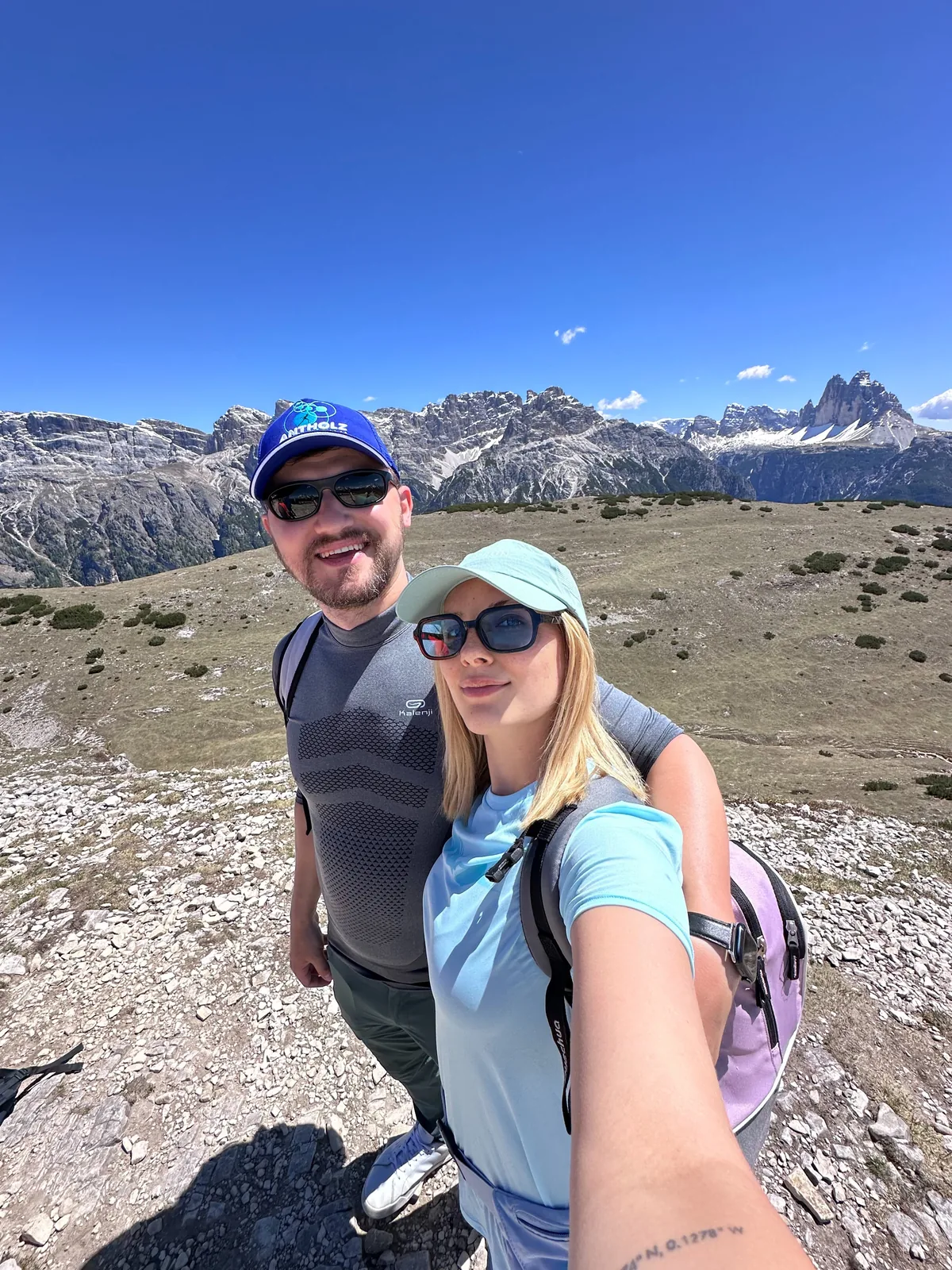 Velena and Dragos on the trail at Prato Piazza in the Dolomites, the Tre Cime di Lavaredo on the skyline behind them