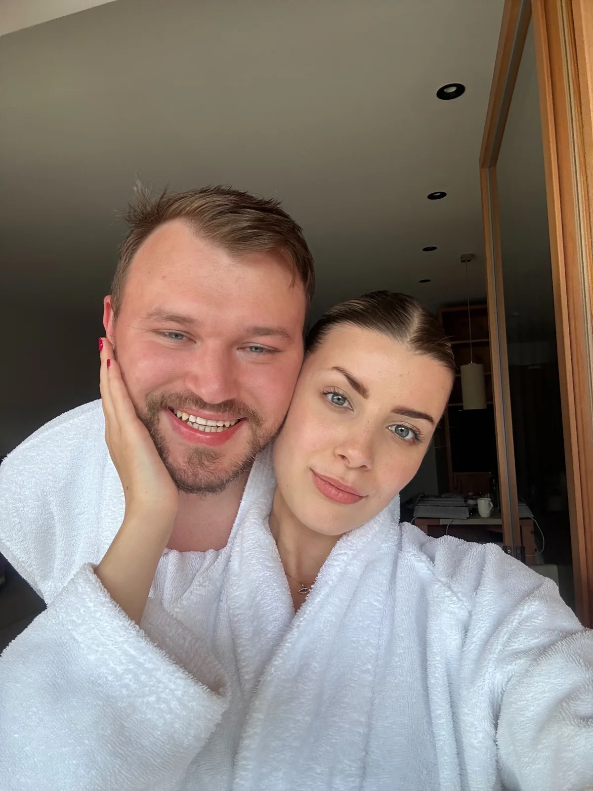 Velena and Dragos in robes on the balcony of their room at the Leitlhof, San Candido